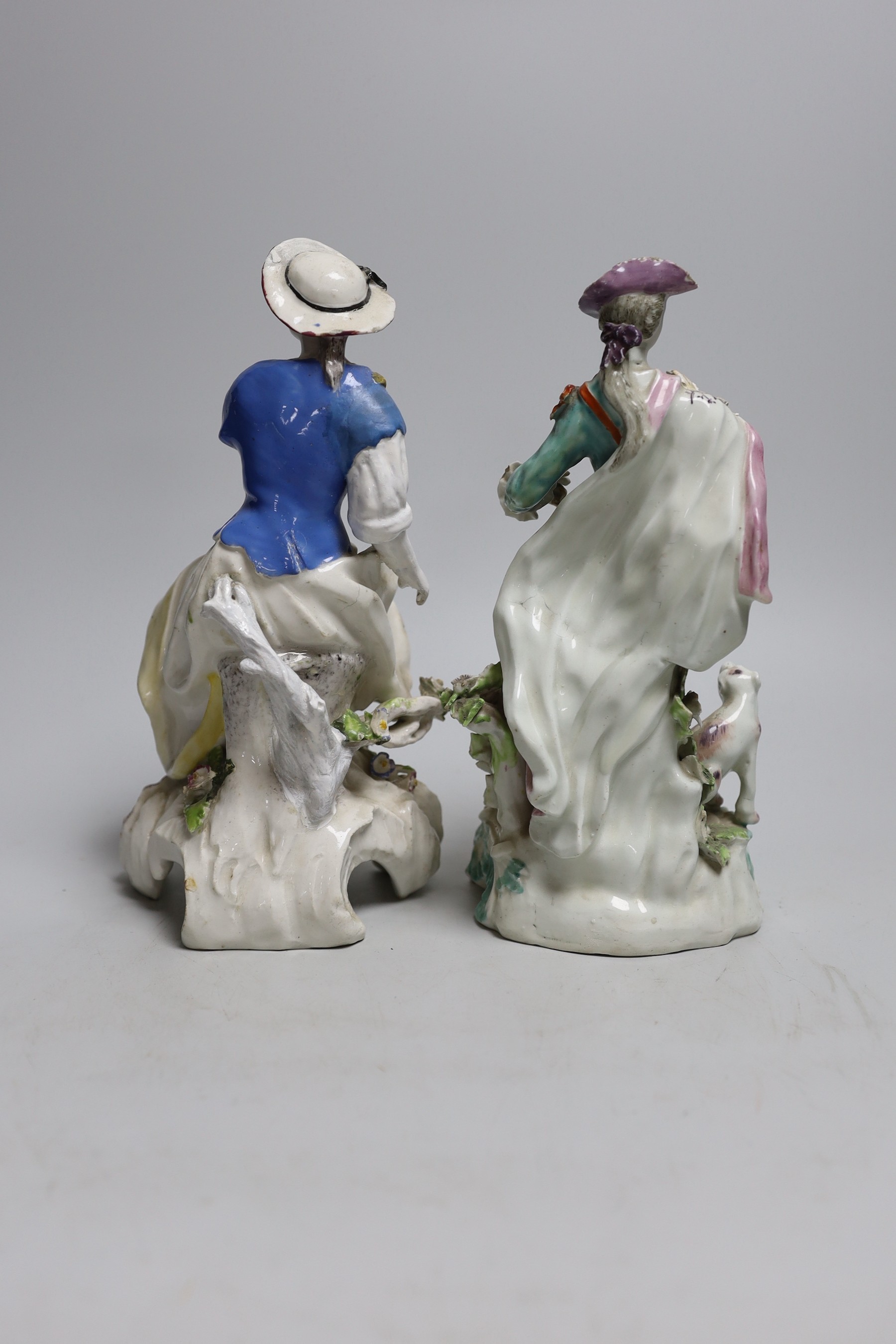 Two 18th century Derby figures: a seated lady and gentleman with a dog, 23cms high
